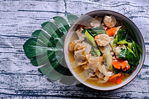 Wide Rice Noodles with Seafood and pork in Gravy Sauce, Asian food. Healthy and tasty menu.