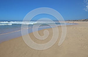 Wide sandy beach in Plettenberg Bay, by the Indian Ocean. South Africa.