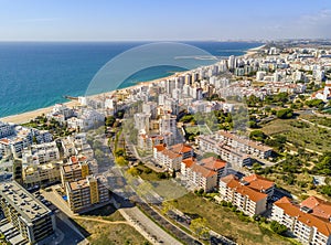 Wide sandy beach in touristic Quarteira and Vilamoura, Algarve,