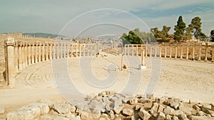 Wide-screnn view of ionic columns situated in Oval Plaza, Jerash, Jordan.
