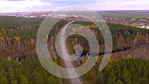 Wide shot aerial drone footage tracking a car