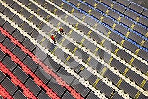 Wide shot of aeroview or top view of two technician workers discuss and work with maintenance or check solar panel system over