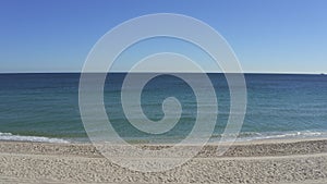 wide shot of beach waves crashing at the shore line in florida