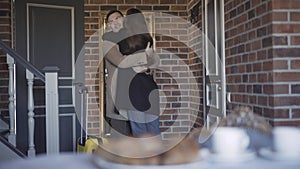 Wide shot of couple of lovers hugging standing in luxurious hotel room with baggage. Portrait of smiling adult Caucasian