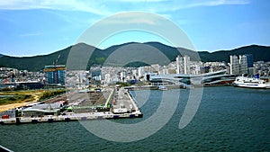 wide shot of cruise ship arriving at busan port of kore