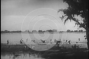 Wide shot of farmers working the land