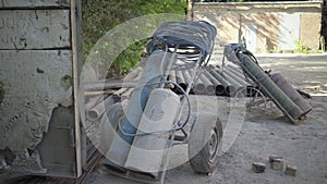 Wide shot of gas tanks and metal pipes in sunlight outdoors. Industrial materials on manufacturing site or factory