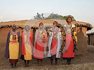 Wide shot of a group of maasai women singing