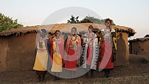 Wide shot of a group of maasai women singing