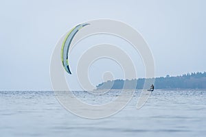 Wide shot of Hydrofoil Kitesurfer in winter conditions at the baltic