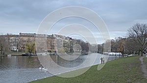 Wide Shot of Landwehrkanal and Planufer, Fraenkelufer in Berlin Kreuzberg. Swans swimming in the canal, seagulls mire