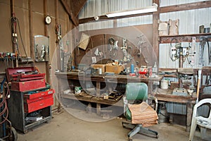 Wide shot of an old barn` s workbench with different types of tools