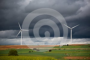 Wide Shot Of Renewable Wind Power Farm Windmills In Motion With A Cloudy Epic Sky In Valdorros In Castile and Leon, Burgos, Spain