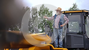 Wide shot senior man waving gesturing inviting to tractors market looking away. Portrait of experienced confident