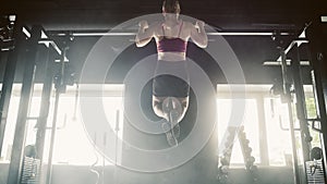 Wide Shot of a Strong Woman With Athletic Body Doing Pullups, Training and Exercising in a Hardcore