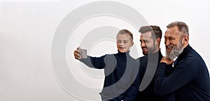 Wide shot of three male generations make selfie