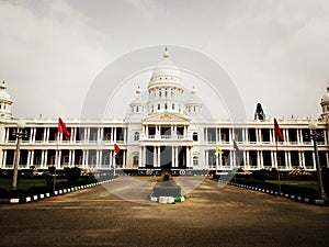 Wide shot of the white building of the Lalitha Mahal Palace Hotel in India