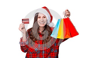 Wide smiling girl is holding some shopping bags she bought for Christmas.