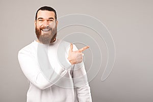 Wide smiling man is showing you the offer he is pointing at.