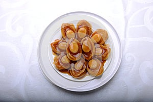 Wide spread of abalone servings in a fine dining setting photo