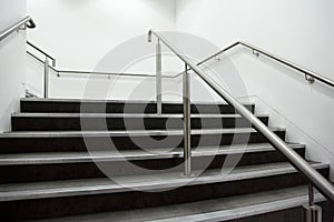 Wide staircase with chrome handrails photo