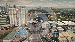 Wide traffic highway road at skyscrapers and billboards aerial. Metropolis city business center