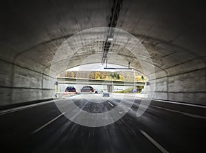 Wide tunnel on a freeway with moving cars