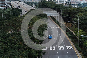 Wide urban freeway Asian metropolis. Modern buildings and structures. Singapore. Highway in dense rainforest