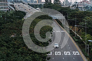 Wide urban freeway Asian metropolis. Modern buildings and structures. Singapore. Highway in dense rainforest