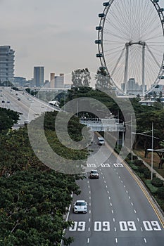 Wide urban freeway Asian metropolis. Modern buildings and structures. Singapore. Highway in dense rainforest