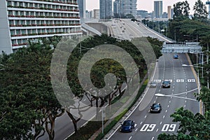 Wide urban freeway Asian metropolis. Modern buildings and structures. Singapore. Highway in dense rainforest