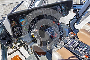 Wide view, a cockpit of a small helicopter, a control panel and a steering wheel.