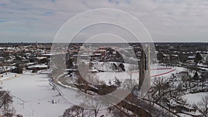 Wide view of drone aerial footage of a Naperville city covered with snow in winter time, american city with a private