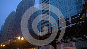 Wide View of element of streets Downtown Chicago Under a Layer of Fog and moving train