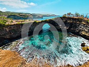 Wide view of the famous Broken bridge of Bali from the cliff. Famous tourist destination in Nusa Penida island in Bali. Beautiful