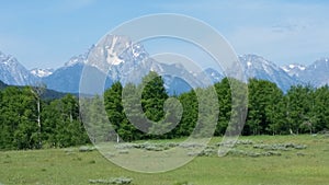 Wide view of Grand Teton mountains with snow capped peaks