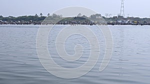 Wide view of large devotees bathing in the huge river during the fair