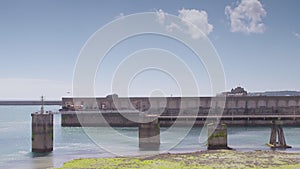 Wide view of a long wall at a harbour