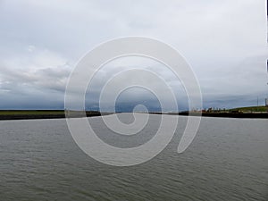 A wide view on the northern sea and the harbor entrance photographed in Norddeich Mole Germany