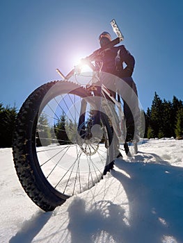 Wide view photo of mountain bike in deep snow. Winter mountains with road
