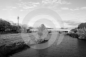Wide view on the river, the bridge and the communication tower in black and white in meppen emsland germany