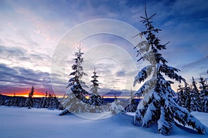 Wide view of a sunset during winter on top of mountains