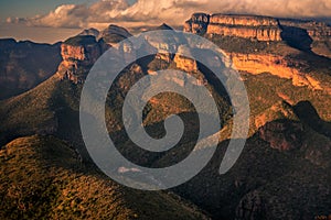 Wide view of the Three Rondavels and surrounding mountain cliffs