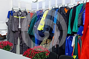 Wide view of  wear clothes, dresses, skirts, trousers, jackets, shoes with shelves, racks and hangers inside fashion retail store
