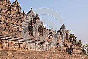 Widening view of Borobudur at the base with plenty of small stupas and buddha statues