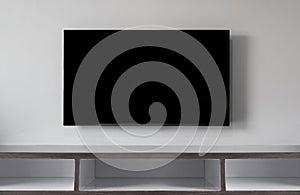 Widescreen television on white wall