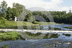 The widest waterfall and beach in Europe in Latvia Kuldiga. River Venta and flying fishes