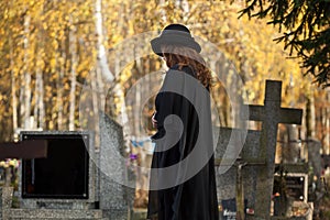 Widow looking at the gravestone