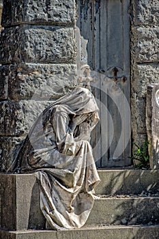 Widow marble statue outside a tomb