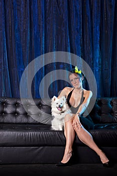 Widow woman in black and white dog on couch